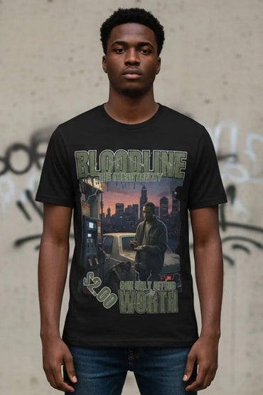 Person wearing a black t-shirt with graphic design and text, standing against a textured wall with graffiti.