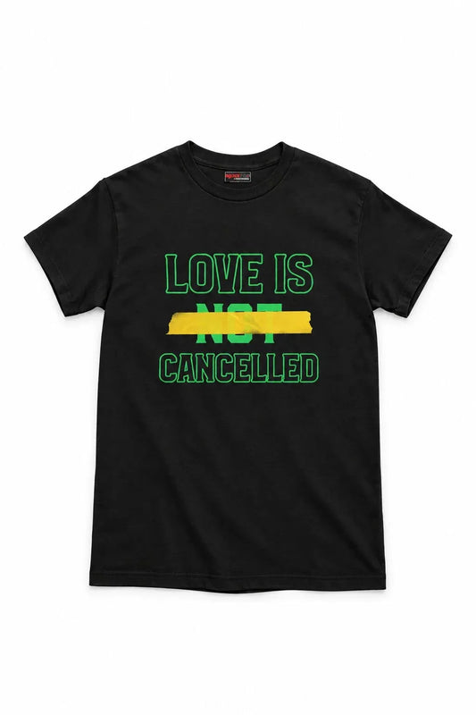 A black short-sleeve crewneck t-shirt with a graphic print on the front reading 'LOVE IS NOT CANCELLED' in green and yellow text, displayed against a plain white background.