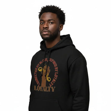 A man wearing a black pullover hoodie with a brown and gold graphic on the chest that reads 'Defending Loyalty' and 'Loyalty is All I Have'.