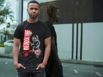 Man wearing a black t-shirt with graphic design and text on a city street.