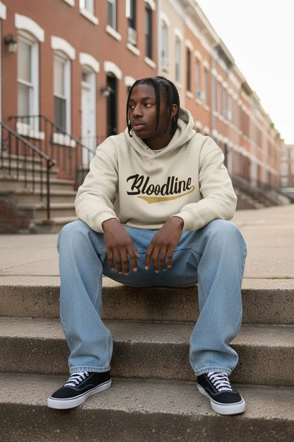 Black male model wearing Bloodline Streetwear Vanilla Drip Signature Hoodie in sand
