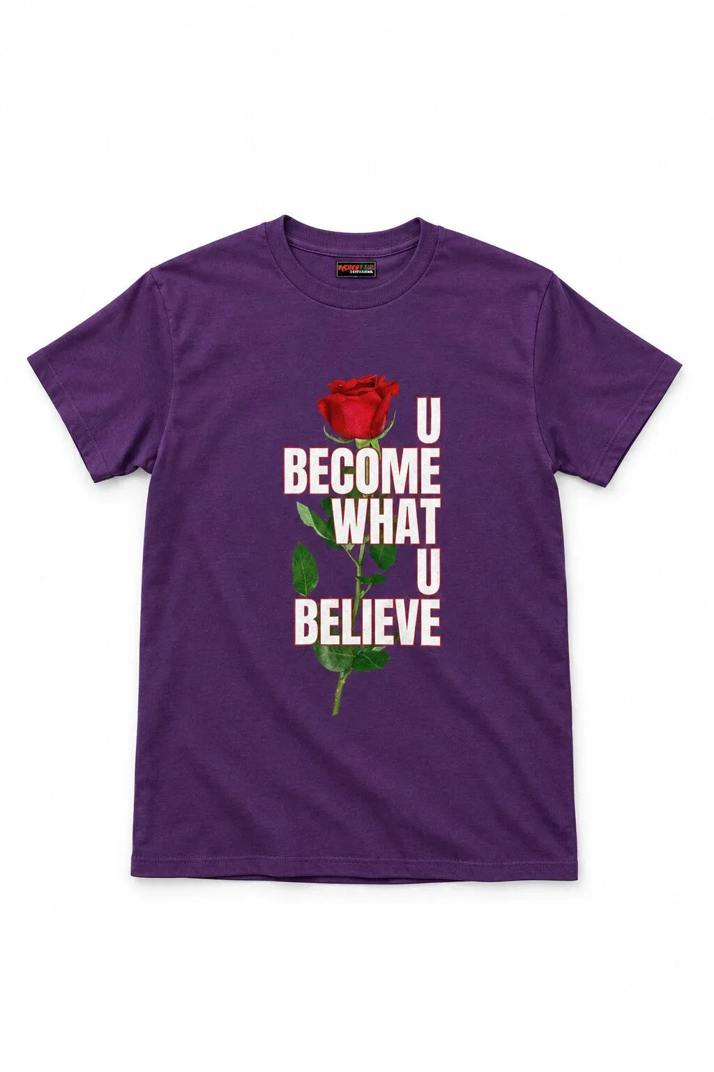 A purple short-sleeve crewneck t-shirt featuring a graphic print of a red rose and the text 'U BECOME WHAT U BELIEVE' in white and green, displayed on a clean white background.